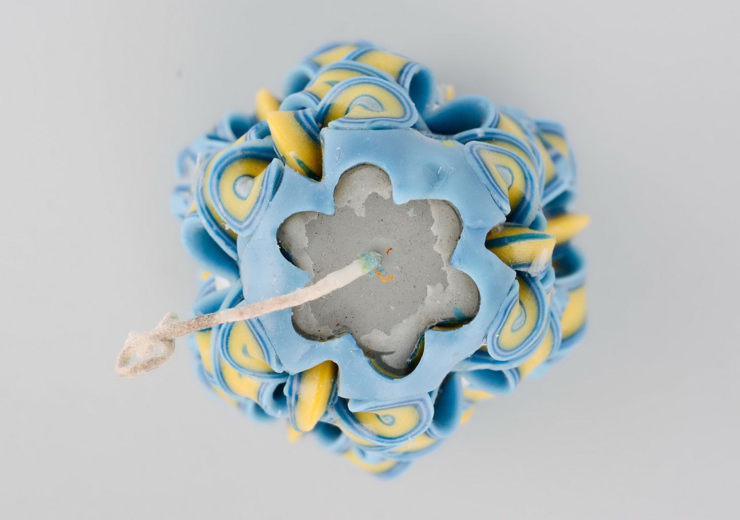 Carved yellow and blue candle