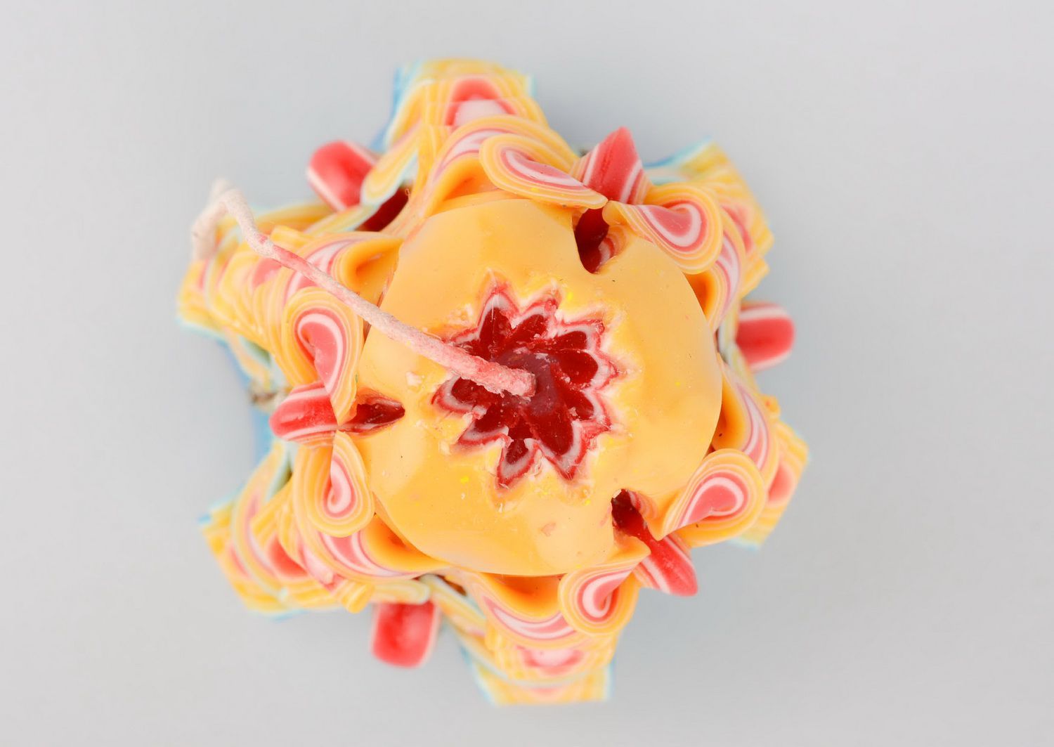 A brightly coloured paraffin candle