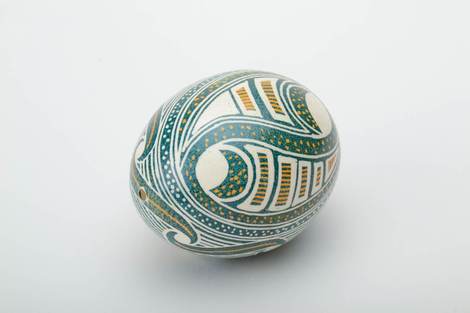 Handmade pysanka in green flowers.