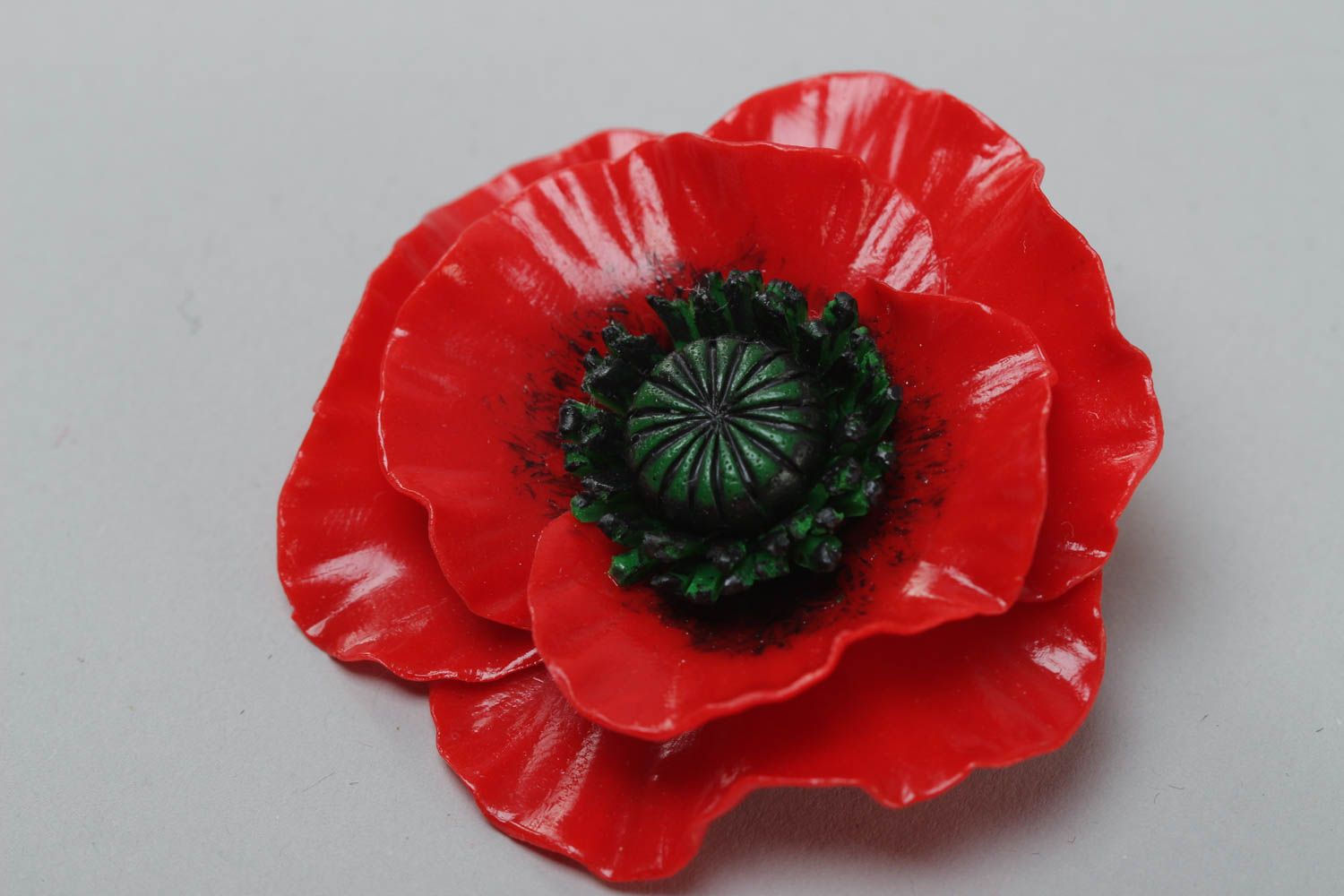 Red poppy brooch.