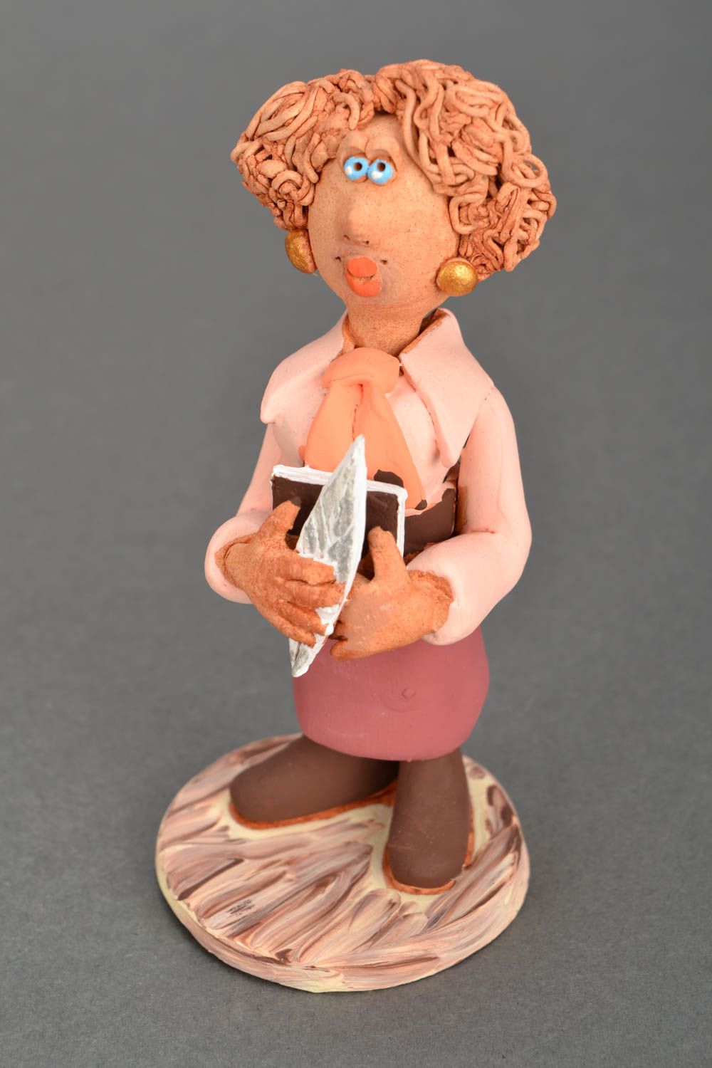 Clay statue of a notary woman 