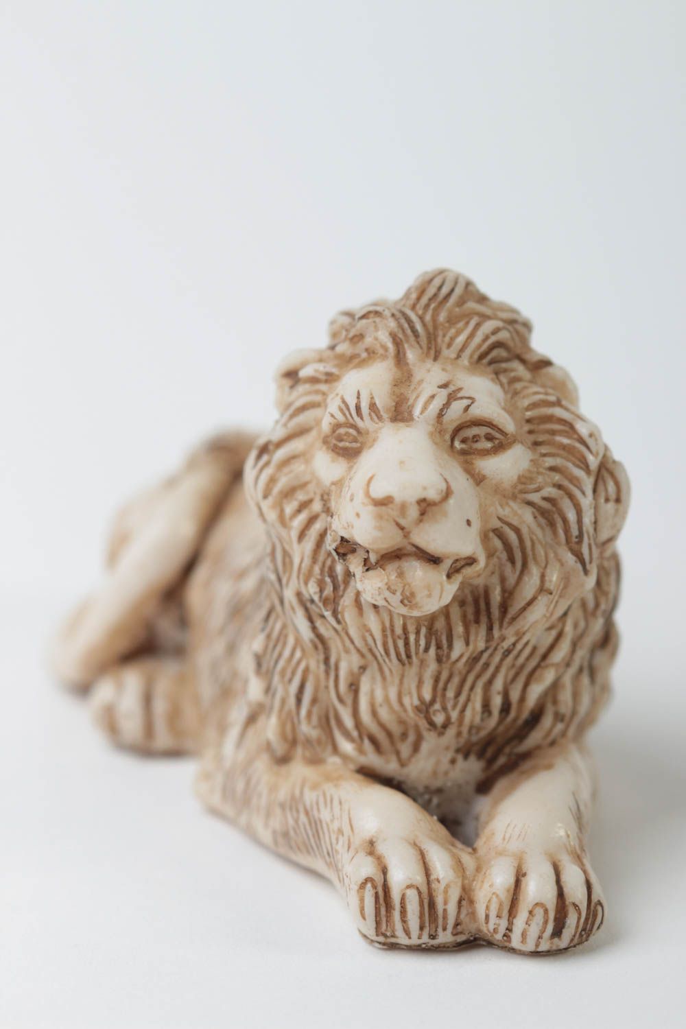 Statuette of lying lion made of polymer resin.