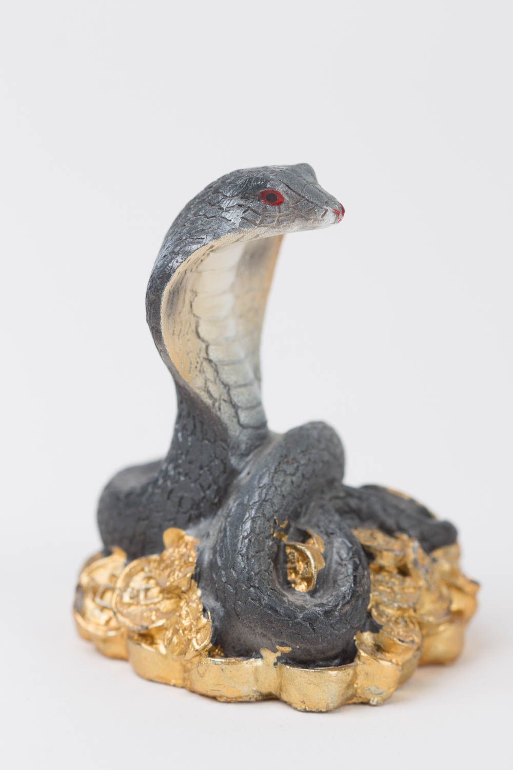 Cobra statuette on polymer resin coins.