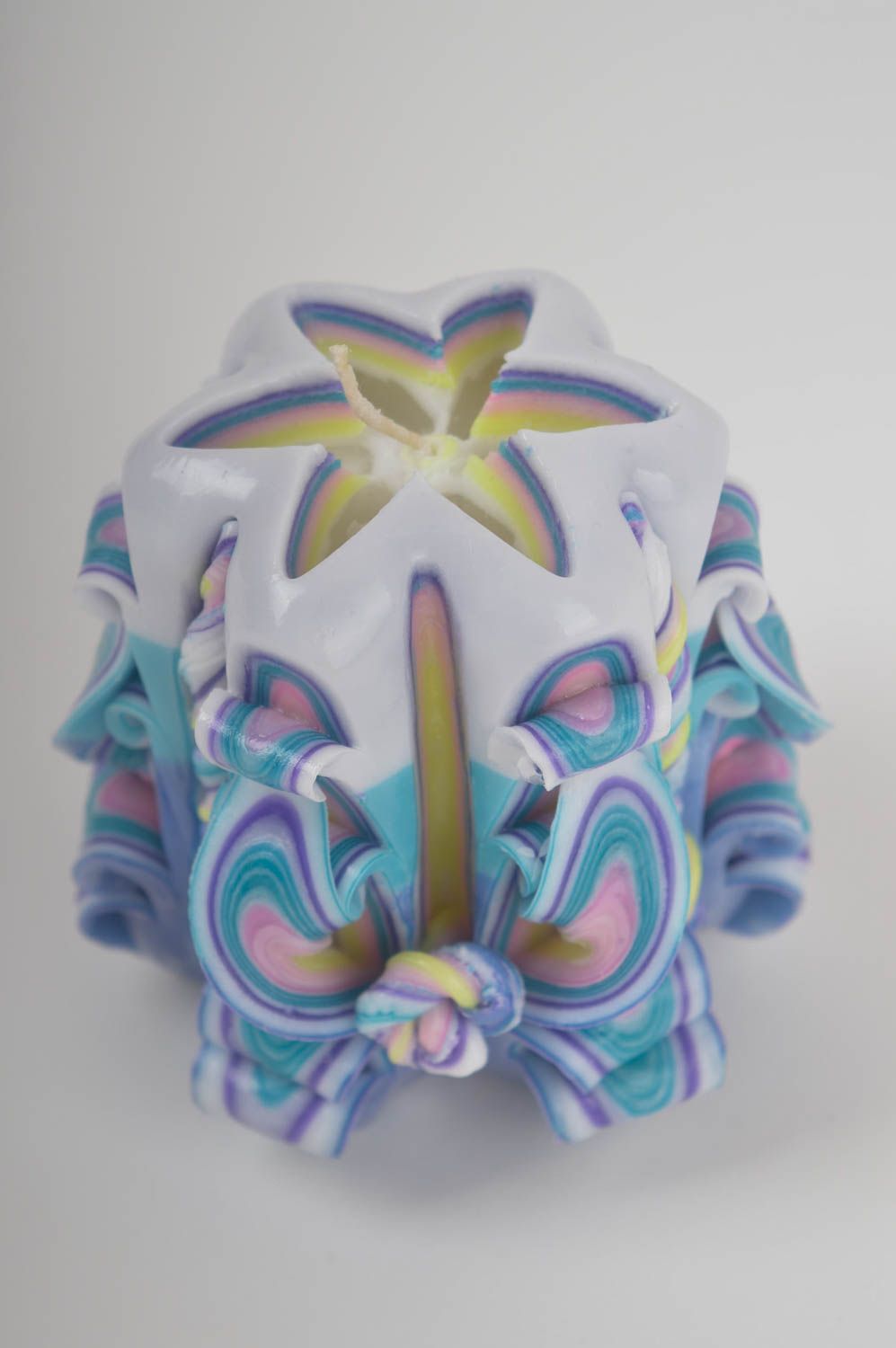 Paraffin candle, decorated with carved patterns by hand.