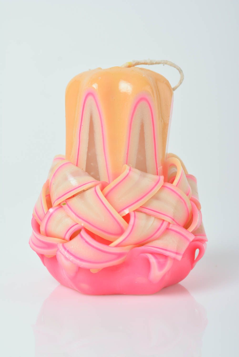 Handmade pink-orange paraffin candle.