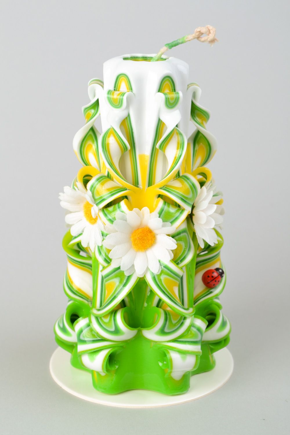 Large carved candle in spring colors.