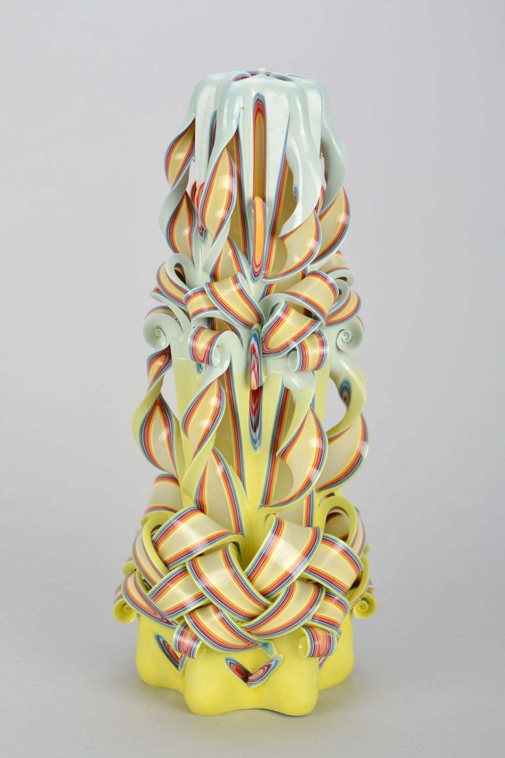 High handmade candle in soft tones.