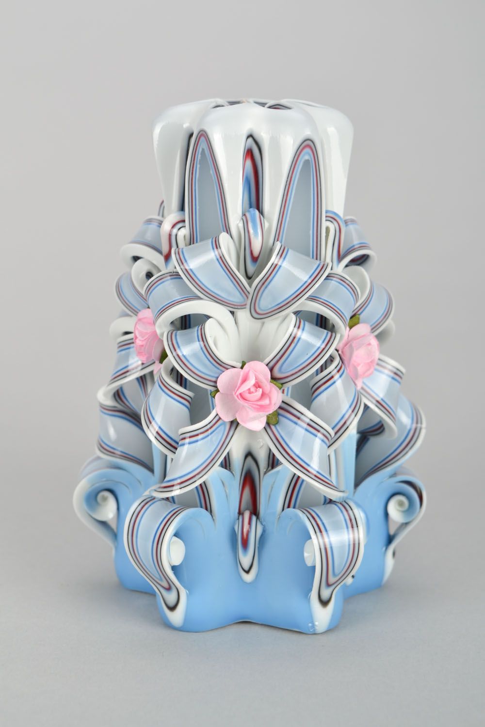 Handmade candle, blue, decorated with flowers and bows.