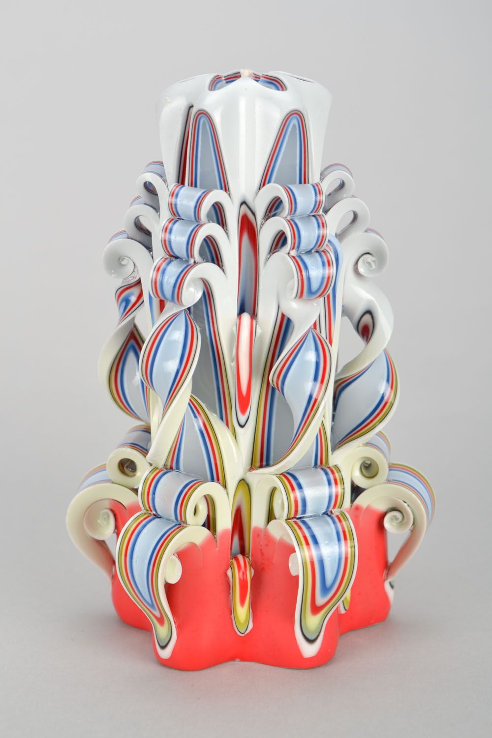 Bright hand-carved candle made of peeled wax.