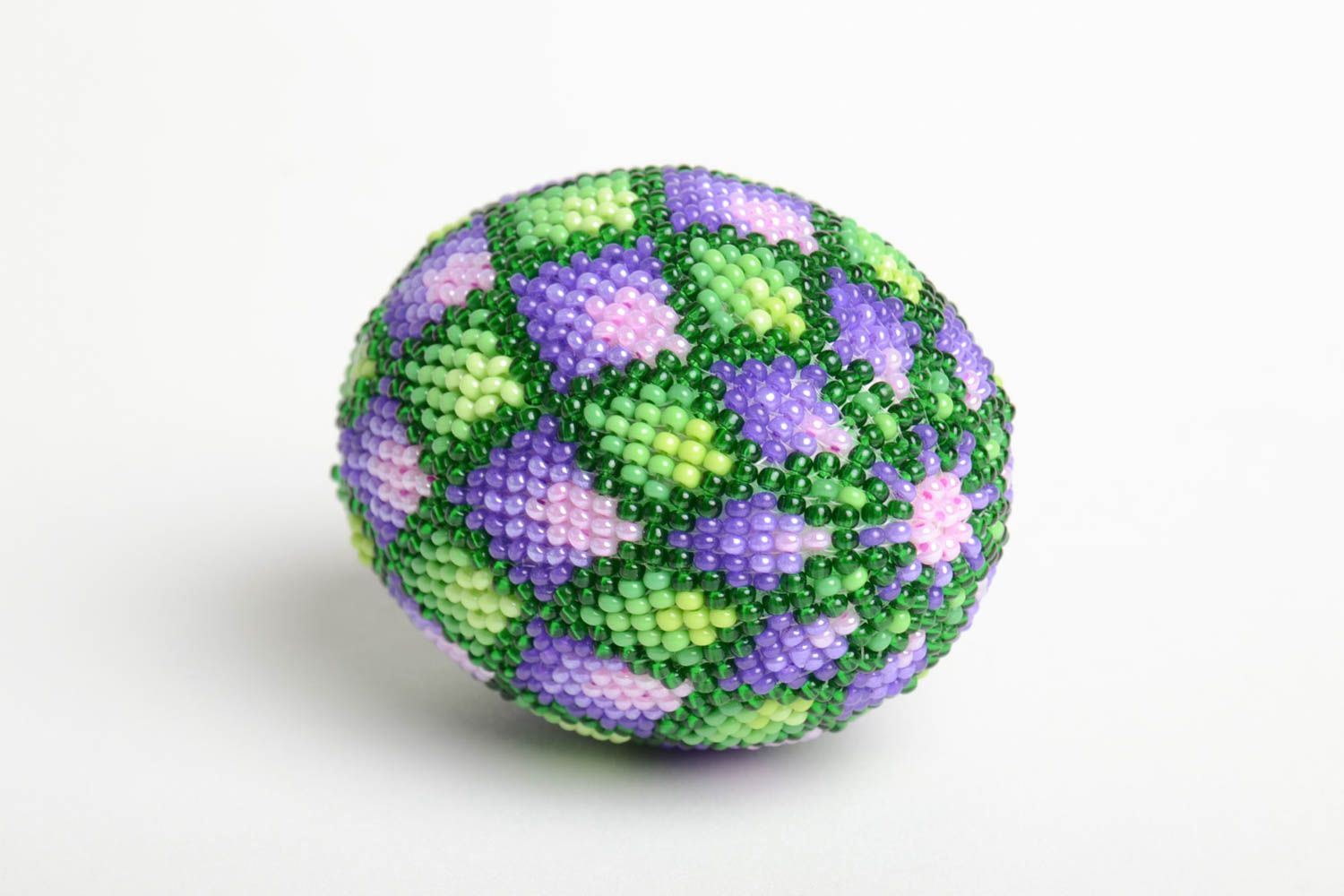 The product - beaded egg with unusual and bright ornament. 