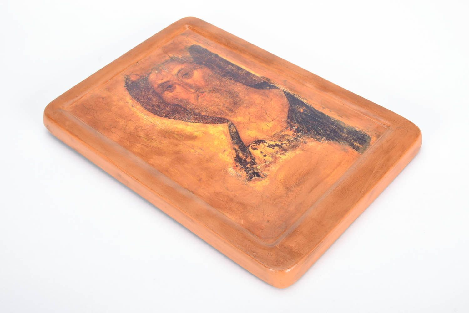 Printed icon of the face of Jesus Christ on a wooden base.