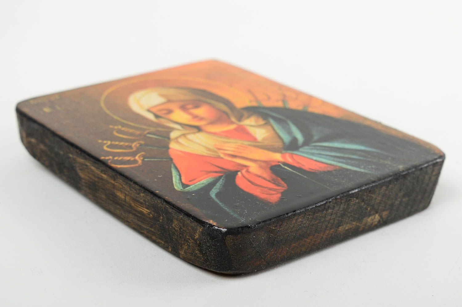 The icon of the Blessed Virgin Mary is handmade of wood.